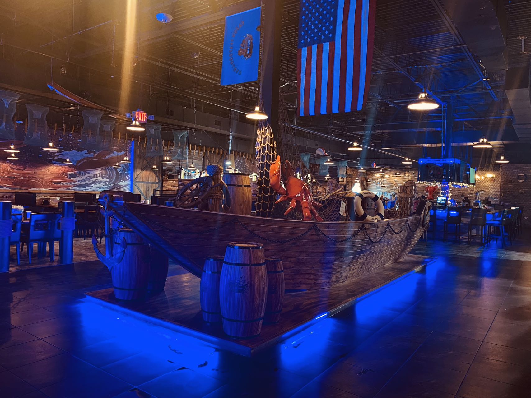 Pirate ship centerpiece with lobster statue and flags in the Boil Bay dining room